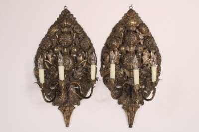 Pair of baroque style brass repoussee wall sconces.